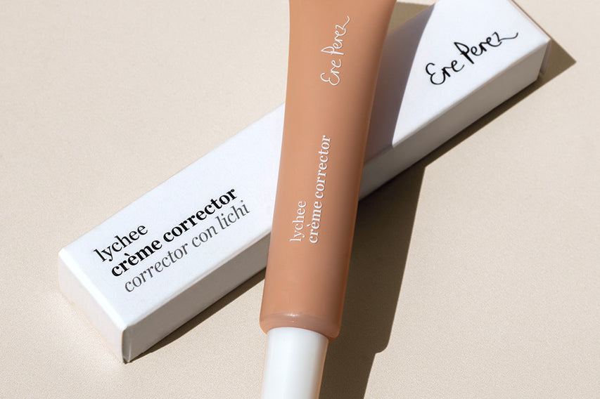 
  
  Ere Perez Lychee Creme Correctors Tres comes in a clear squeeze tube with a white screw-on top placed atop its white box.
  
