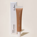 
  
  Ere Perez Lychee Creme Correctors Cinco comes in a clear squeeze tube with a white screw-on top, standing with its white box.
  
