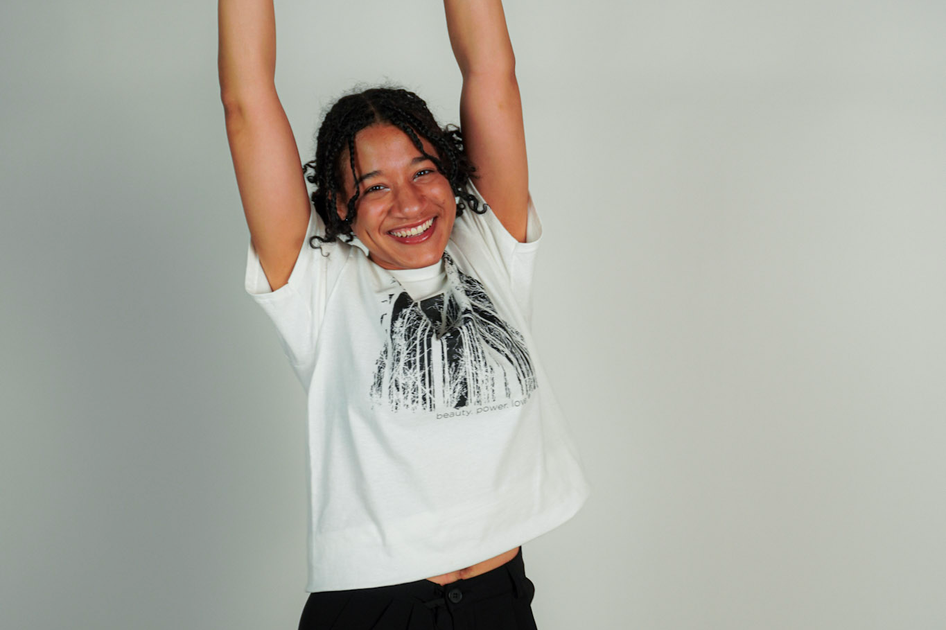 
  
  Person wearing LORDE Beauty Power Love Artist Designed Graphic T-Shirt
  
