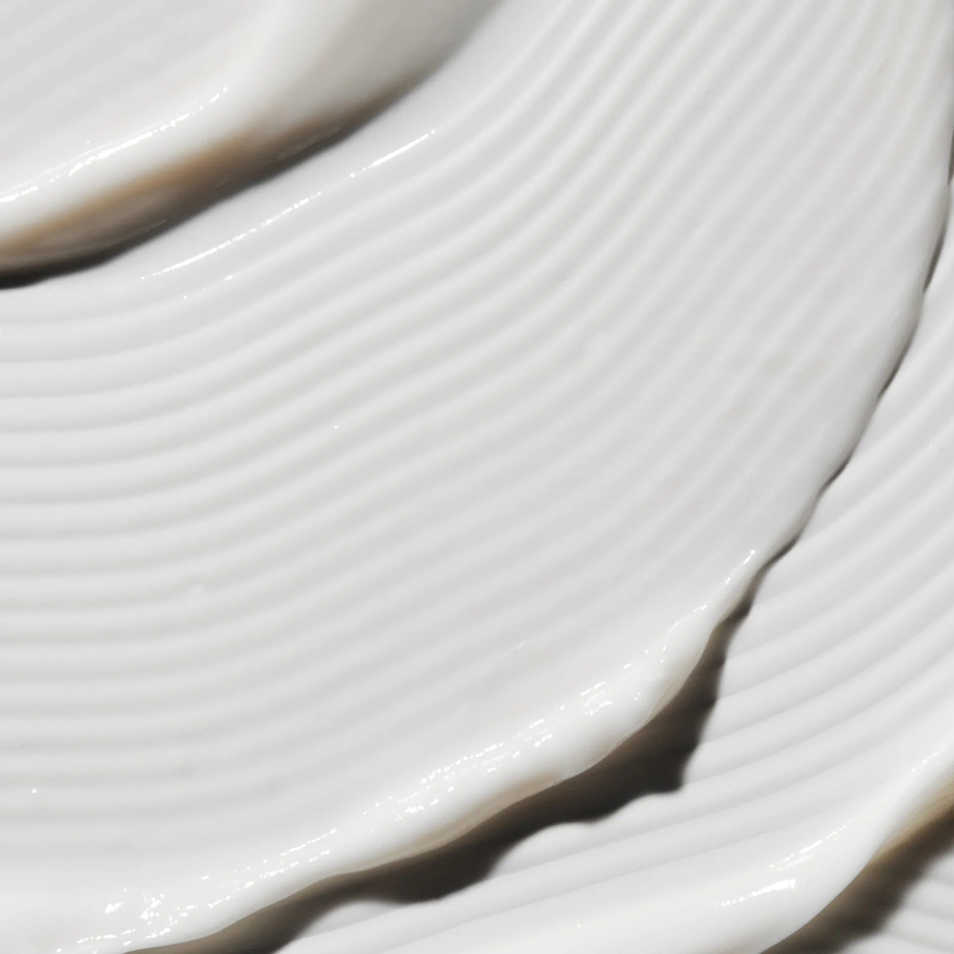 
  
  Close-up of the Omorovicza Gold Rescue Cream showing its thick, creamy consistency and white color.
  
