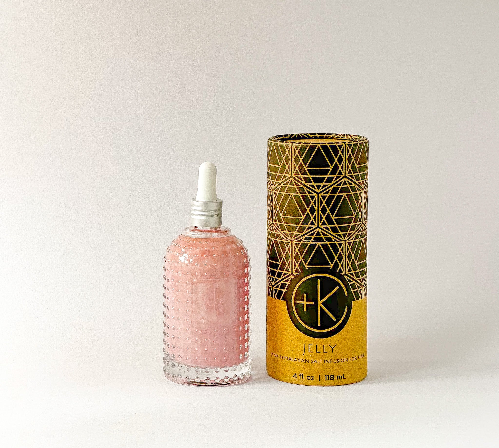 
  
  Textured glass bottle of Cult + King's Jelly with a white eyedropper top beside its cylindrical cardboard and black box.
  
