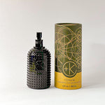 
  
  Textured black glass bottle of Cult+King TONIK with an atomizer top, beside its cylindrical cardboard and black box.
  
