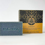 
  
  Cult + King's dark blue Shampoo Bar with an embossed logo next to its abstract patterned black and cardboard package.
  
