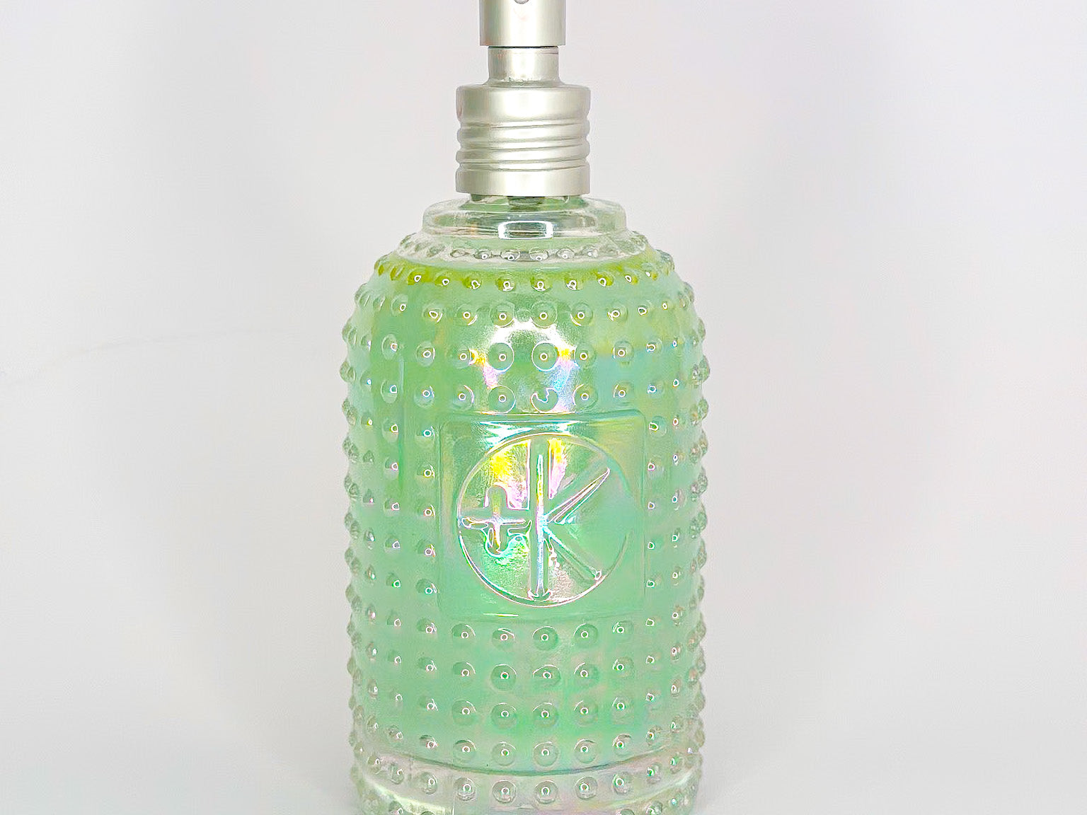 
  
  Textured glass bottle of Cult + King SETSPRAY with an atomizer top.
  
