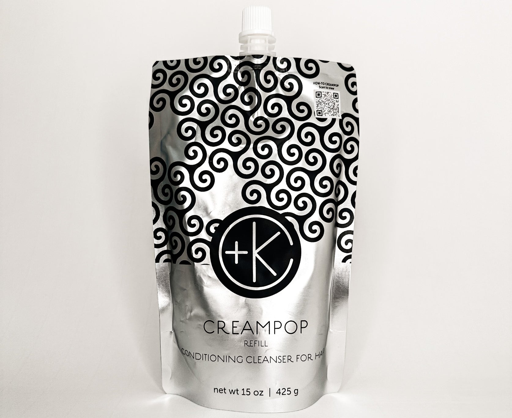 
  
  Cult + King CREAMPOP Refill pouch with a silver and black swirl-pattern and a small white screw-on cap.
  
