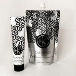 
  
  Cult + King CREAMPOP Cleansing Conditioner in a black-and-white swirl-patterned squeeze tube, beside its silver refill pouch.
  
