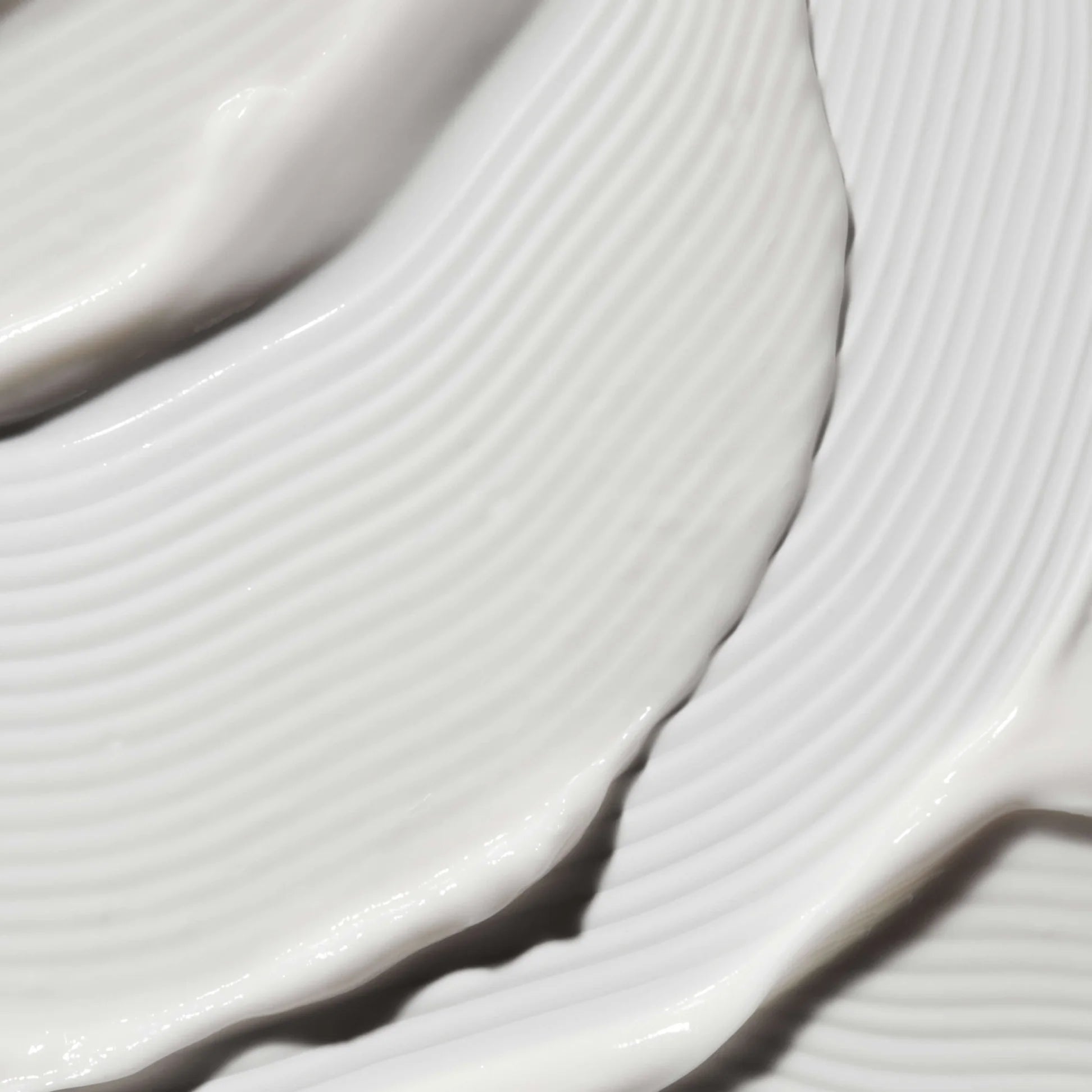 
  
  Close-up of the Omorovicza Illuminating Moisturizer showing its velvety white color and rich consistency.
  
