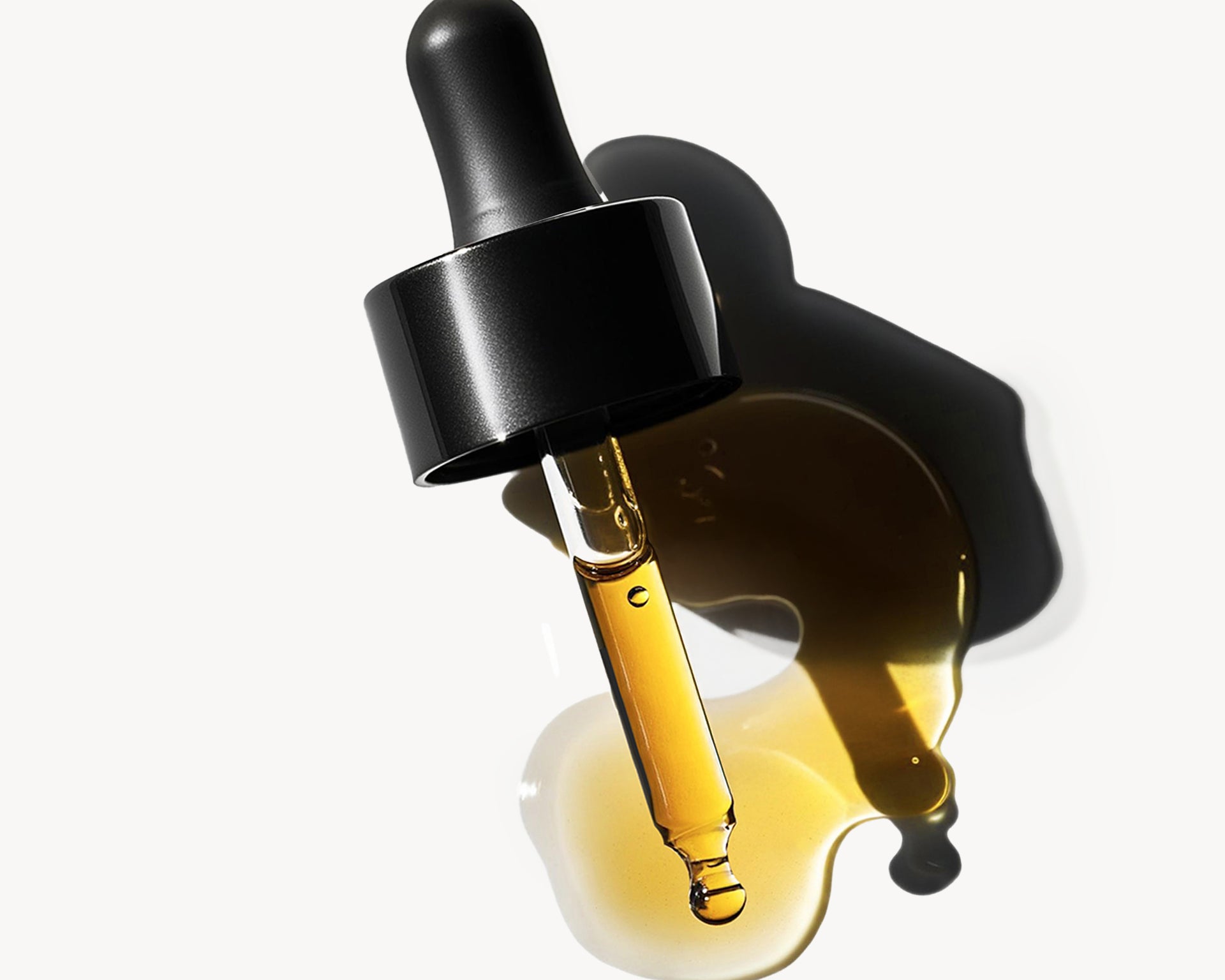 
  
  Black dropper bottle with plum beauty oil on a white background
  
