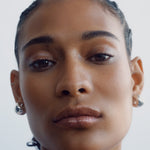 
  
  Close-up of a woman's face with braided hair showing Chameli Tinted Potion on lips, cheeks, and eyes against a white background
  
