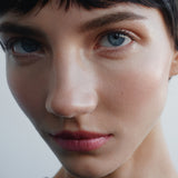 
  
  Model showing Igazi Tinted Potion on lips, cheeks, and eyes.
  
