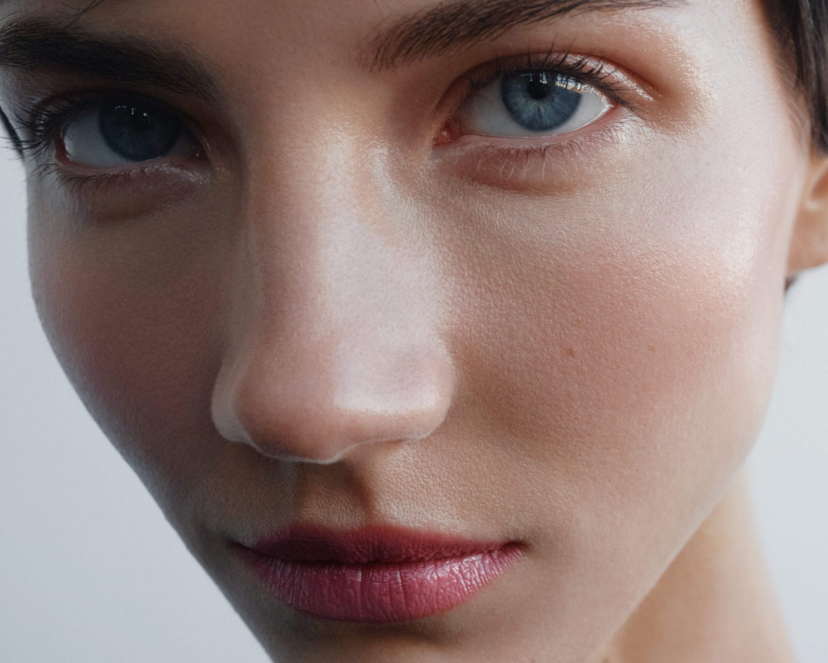 
  
  Model showing Igazi Tinted Potion on lips, cheeks, and eyes.
  
