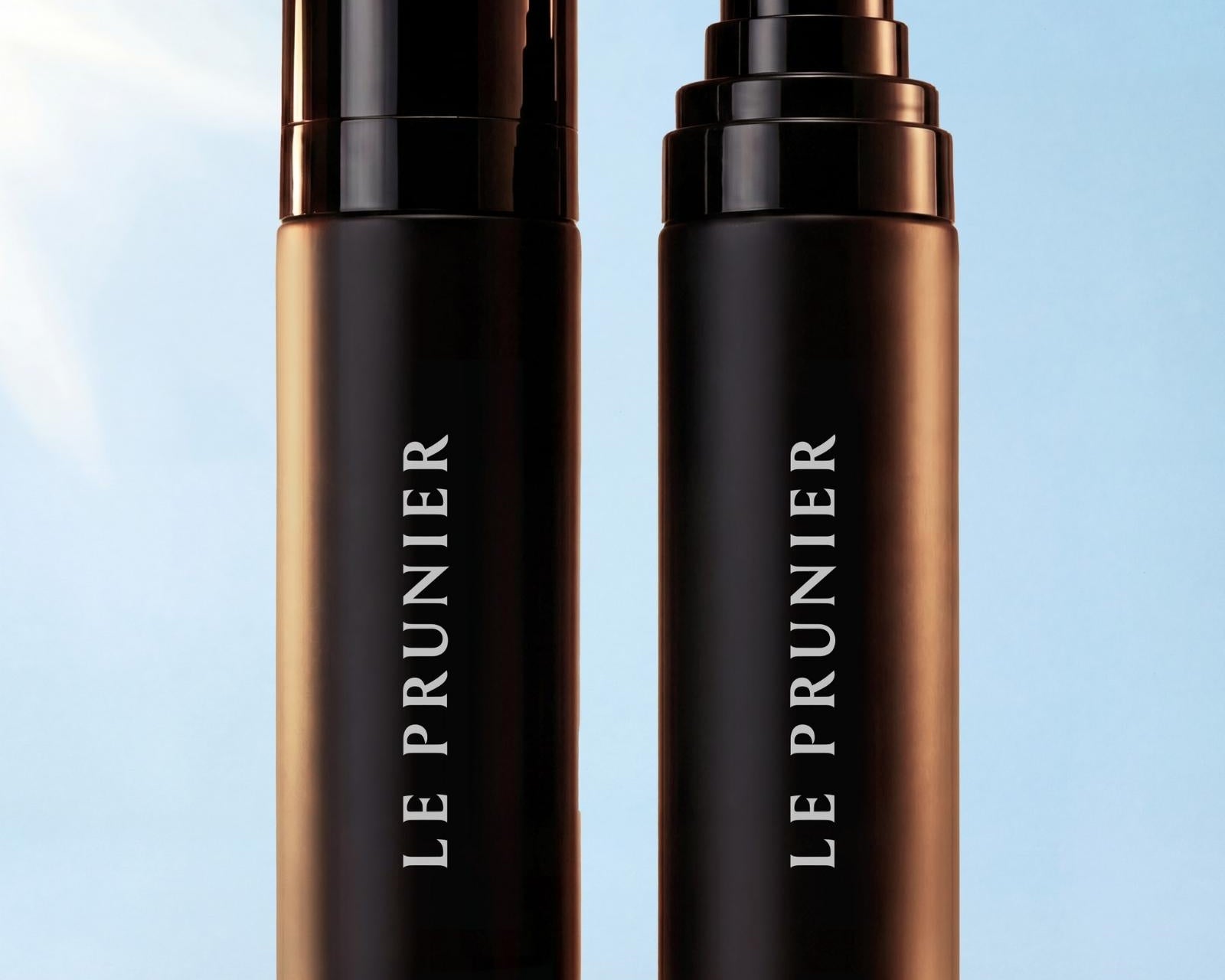 
  
  Two bottles of Le Prunier Plum Spritz on a light blue background
  
