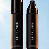 
  
  Two bottles of Le Prunier Plum Spritz on a light blue background
  

