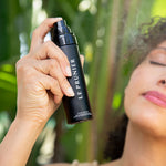 
  
  Person holding a Le Prunier sPlum Spritz against a blurred green background
  
