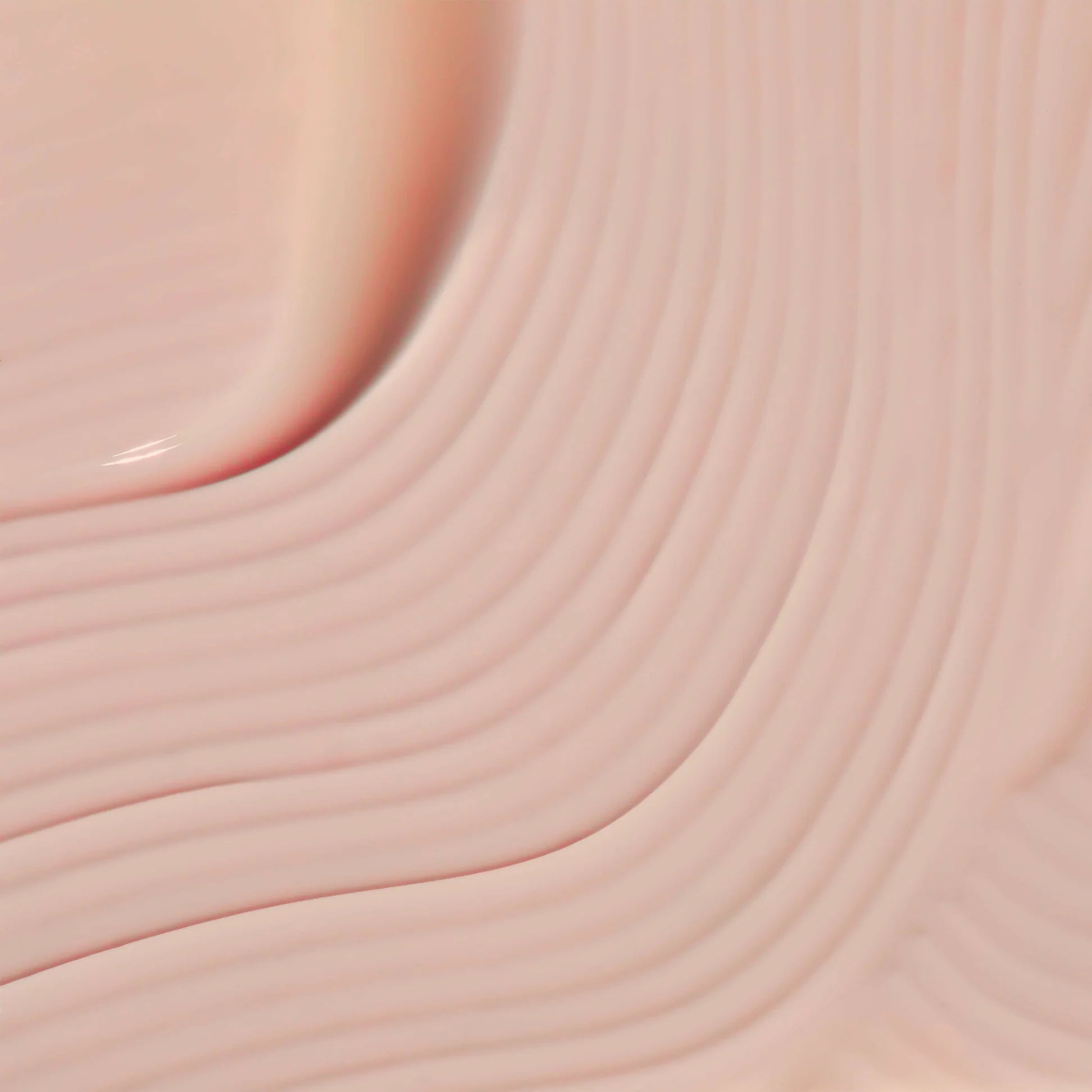 
  
  Close-up of the Omorovicza Queen Serum showing its glossy pink color and a silky consistency.
  
