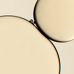
  
  A Close-up droplet of Omorovicza Miracle Face Oil shows its yellow hue and radiant oil consistency.
  
