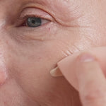 
  
  Oatmilk Foundation Latte, a fair to light flexible foundation shade, where model is applying the foundation and showing the finish.
  
