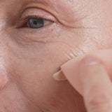
  
  Oatmilk Foundation Latte, a fair to light flexible foundation shade, where model is applying the foundation and showing the finish.
  
