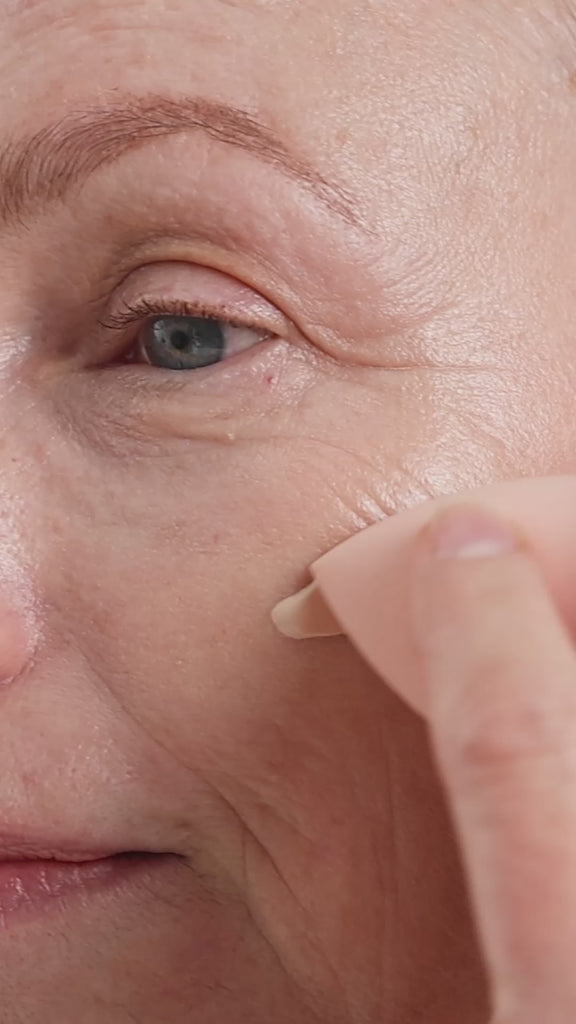Oatmilk Foundation Latte, a fair to light flexible foundation shade, where model is applying the foundation and showing the finish.