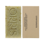 
  
  ORRIS Le Botaniste green speckled Botanical Face + Body Cleansing Bar with embossed logo, next to a tan box with black text
  
